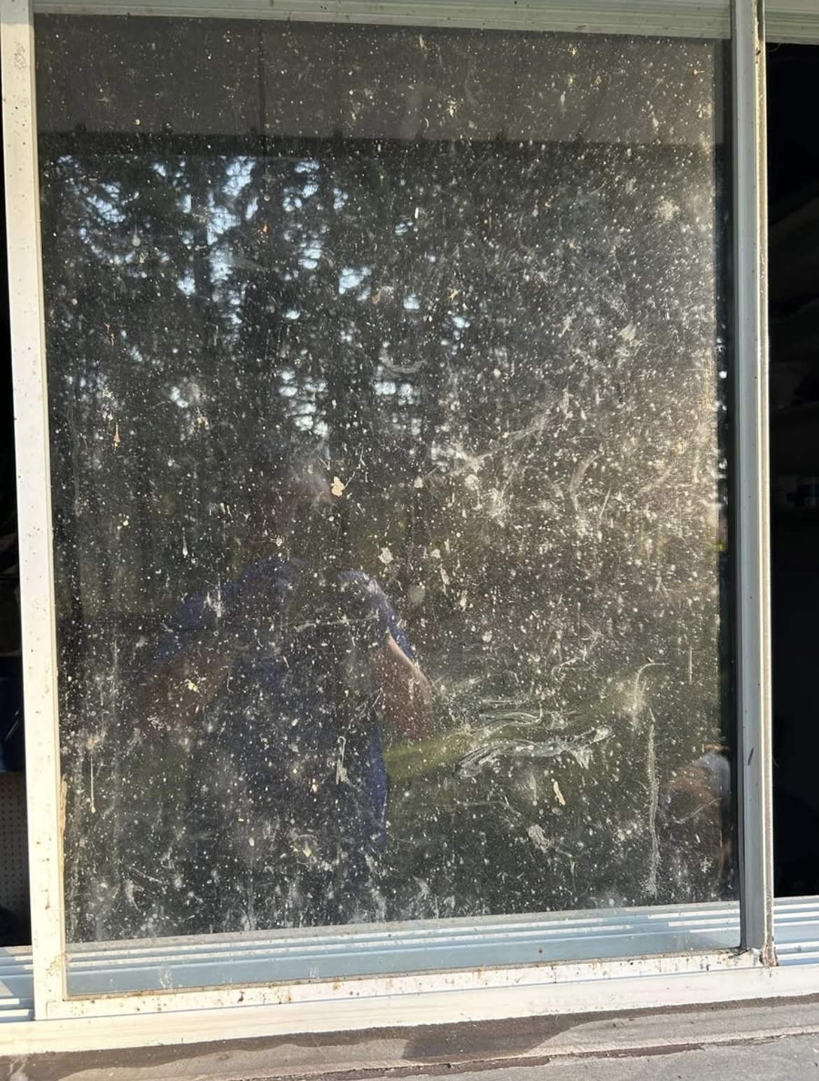 Shop window caked in dust and splatter before cleaning